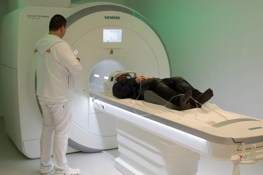 1.5T MRI device in use.